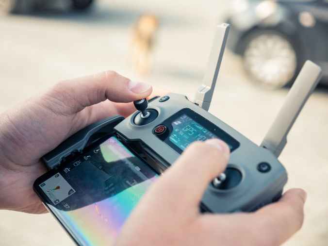 person holding drone remote